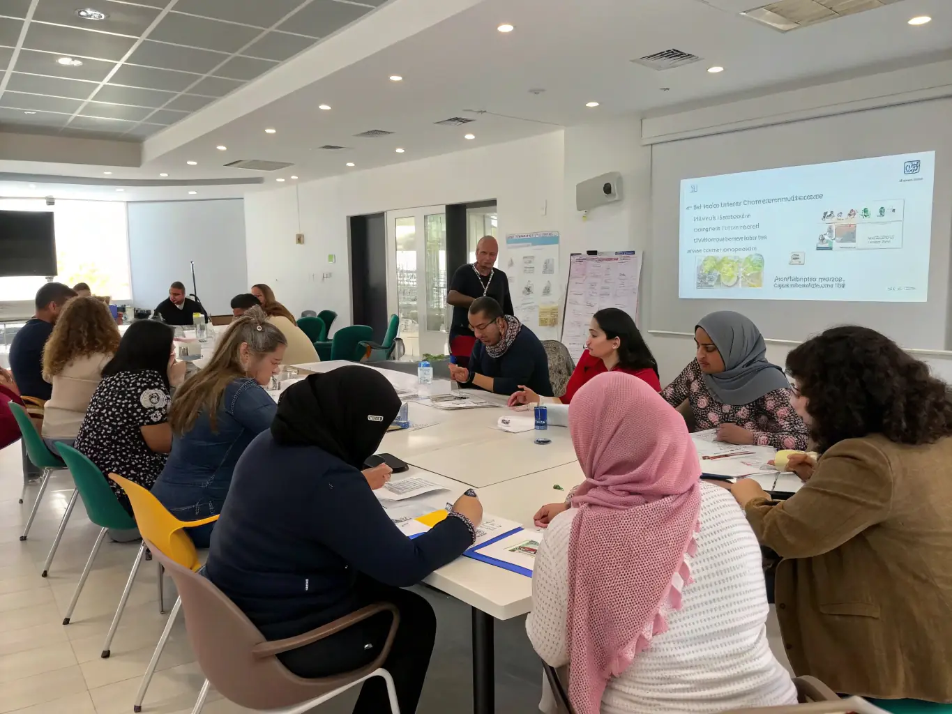 A photo of a training session in progress, with participants actively learning and engaging with the instructor, showcasing hands-on training and skill development.